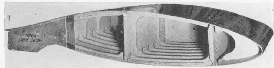 Photograph of a large wing section model cut open to show internal ribs and spars